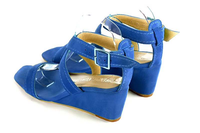 Electric blue women's fully open sandals, with crossed straps. Square toe. Medium wedge heels. Rear view - Florence KOOIJMAN